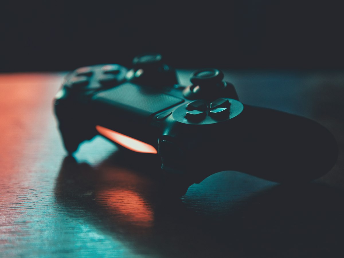 Game controller in orange and blue light