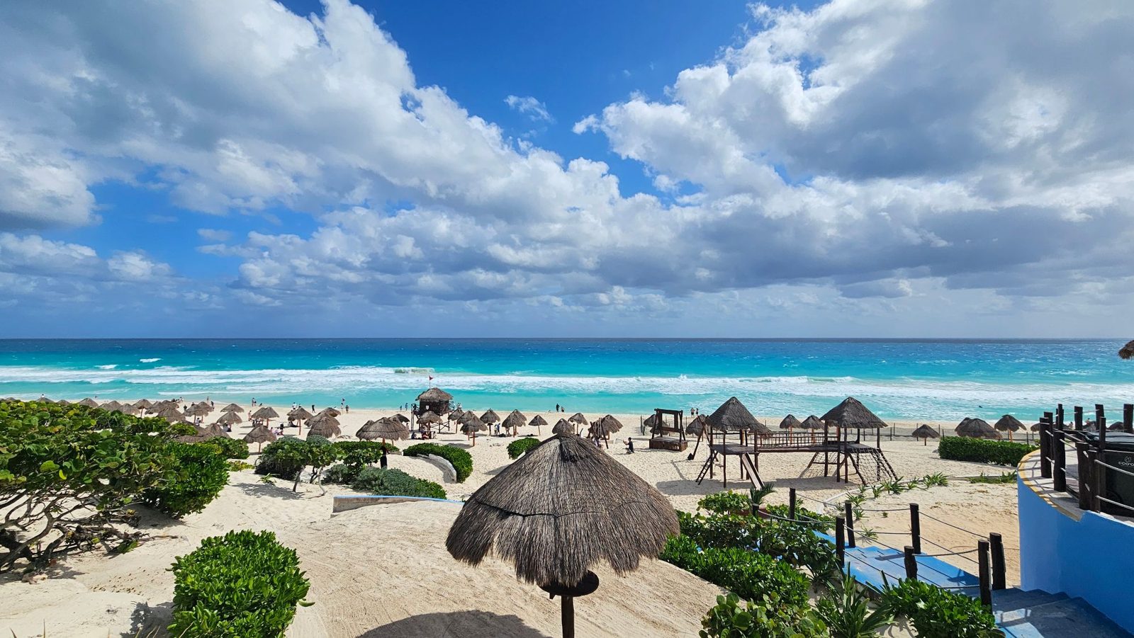 White sand beach with thatched umbrellas and a turquoise sea